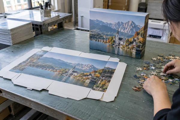 flat unfolded printed puzzle box proof beside a folded sample